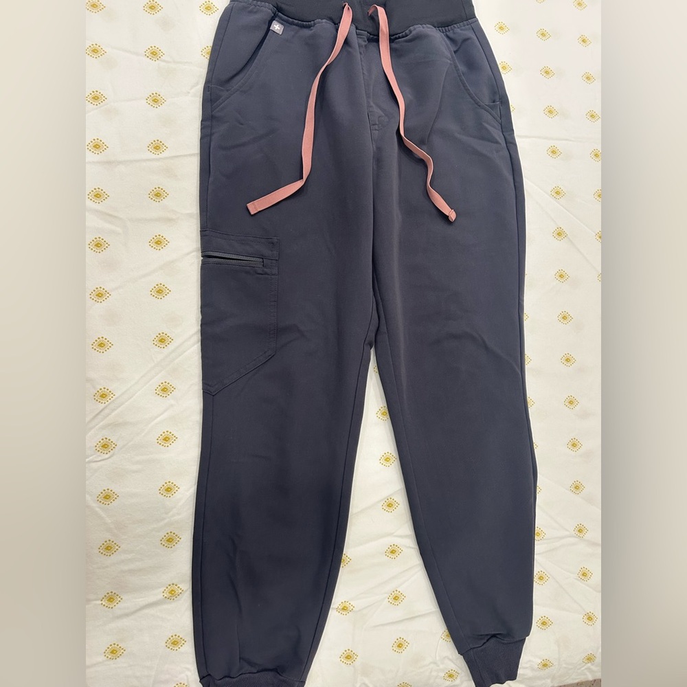 FIGS Charcoal High-Waisted Zamora Jogger Scrub Pants with light pink tie